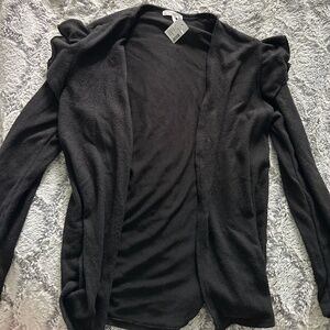 Maurice’s black cardigan with detailed sleeves